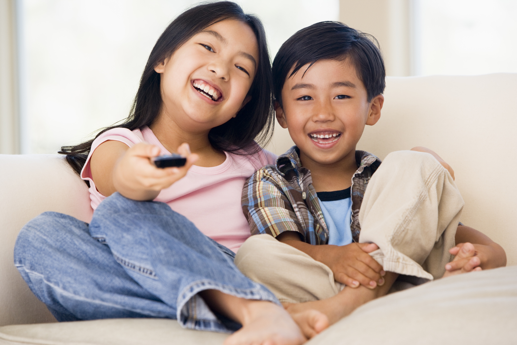Batang 90s A girl and boy sat on couch happily watching TV