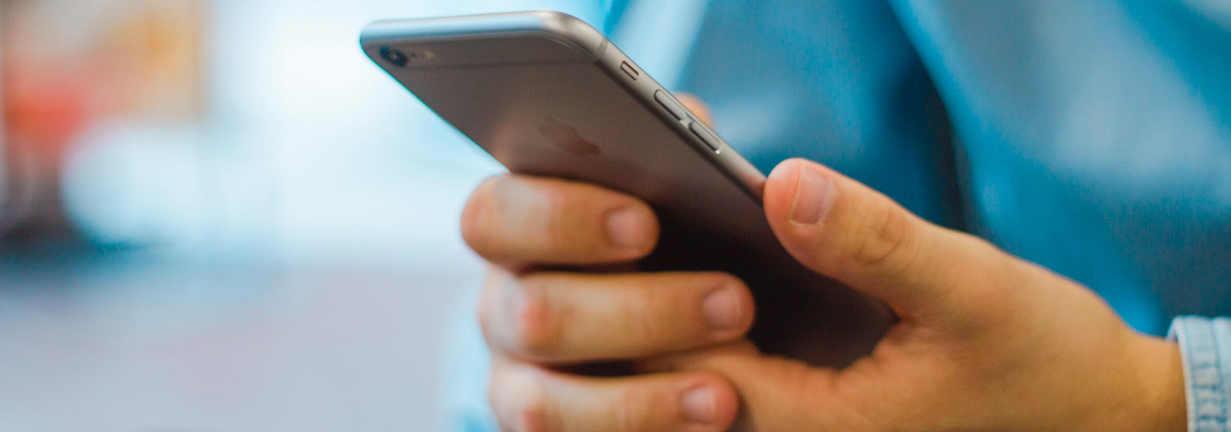 pricing main picture man holding an iphone