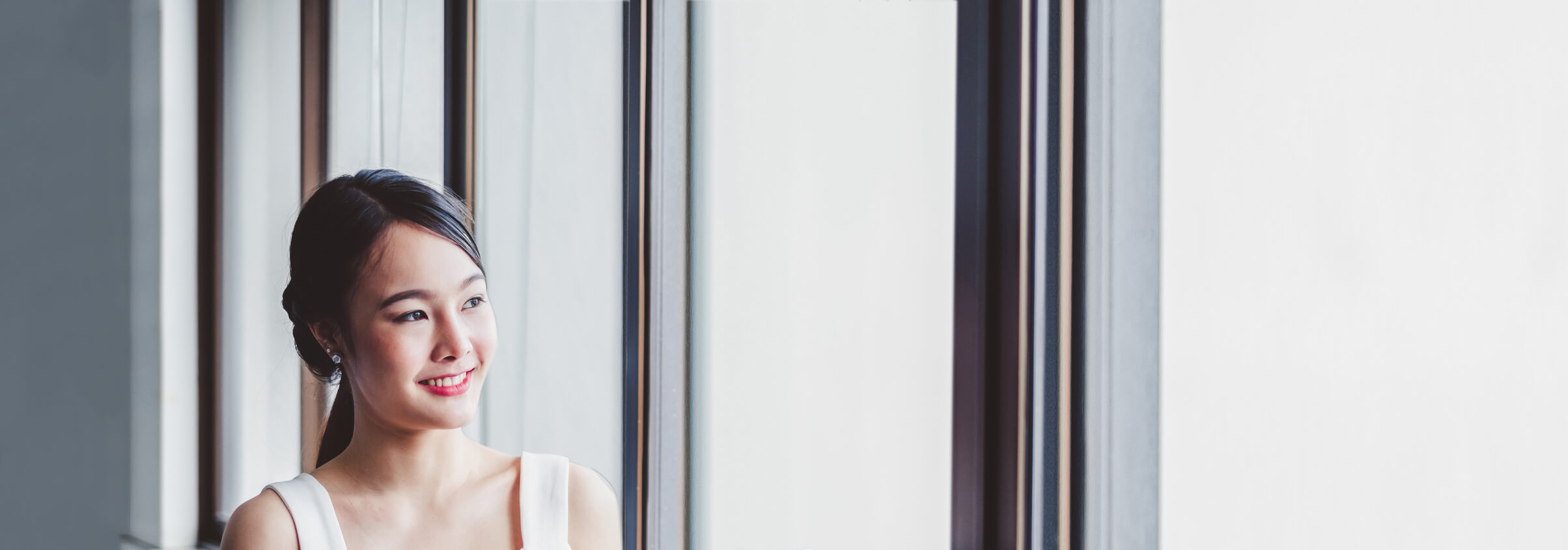 filipino young woman looking through the office window